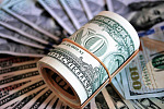 Love and Money Part 1: Photo of a roll of dollar bills, with bills of larger denominations fanned out beneath